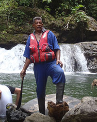 Hikemaster Snakeman giving instructions in front of a waterfall