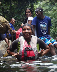 Happy hikers enjoying a swim in a river in Triniodad and Tobago